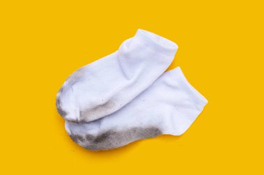 Sarı arka planda kirli beyaz çoraplar.