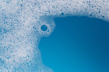 Deterjan köpüklü su. Mavi arkaplan, sabun suyu