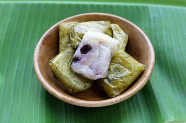 Muz yapraklarına sarılmış muz ve siyah fasulyeli haşlanmış pirinç.