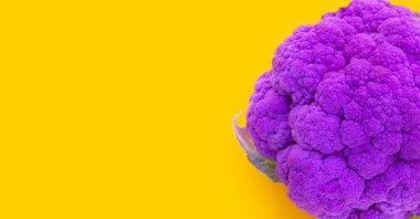 Purple cauliflower on yellow background.