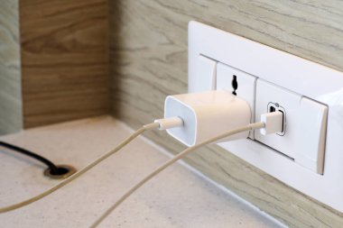 Elektrik prizi, prize takılı bir telefon.
