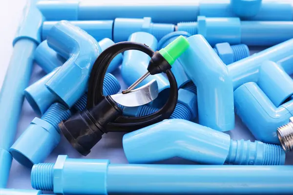 Sprinkler with blue pvc pipe connections for plumbing work.
