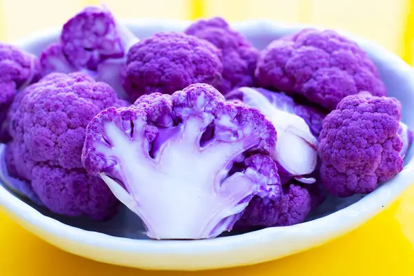 Purple cauliflower on yellow background.