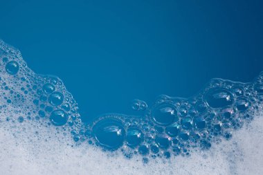Deterjan köpüklü su. Mavi arkaplan, sabun suyu
