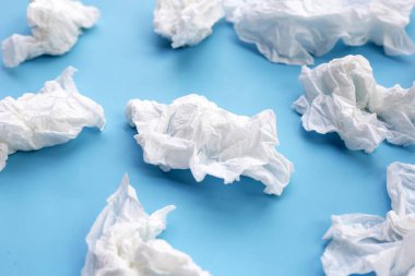 Buruşmuş kağıt mendil. Mavi arka planda yüz dokusu.