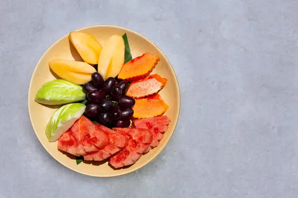 Fresh fruits in plate. Exotic fruits
