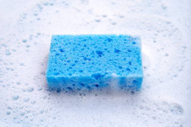 Bulaşık deterjanı köpüklü temizlik süngeri. Bulaşık yıkama kavramı