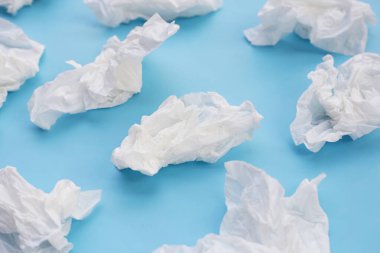 Buruşmuş kağıt mendil. Mavi arka planda yüz dokusu.