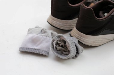 Kirli çoraplı siyah spor ayakkabılar.