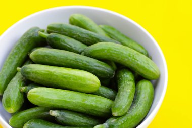 Beyaz kasede küçük salatalıklar.