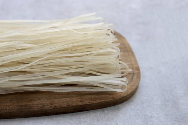 Dried uncooked rice noodles. Raw rice flour noodles clipart