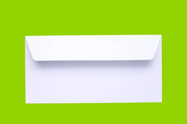 stock image White envelope on green background.