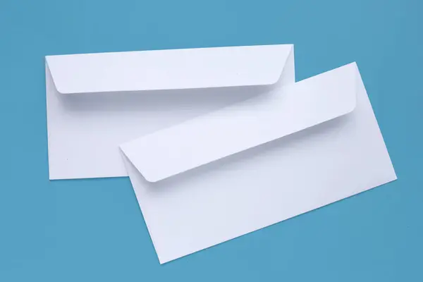 stock image White envelope on blue background.