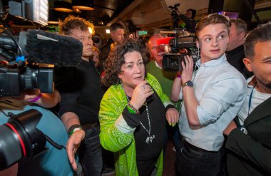 BATHMEN, THE NETHERLANDS - MAR 15, 2023: Politician Caroline van der Plas is curious to read the results on a TV screen of the provincial elections in which her party BBB wins. clipart