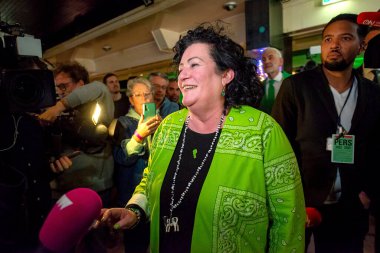 BATHMEN, THE NETHERLANDS - MAR 15, 2023: A happy politician Caroline van der Plas gives interviews to the press after her political party BBB wins the provincial elections. clipart