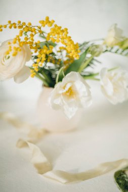 a bouquet of spring flowers on a light background, Easter floristry