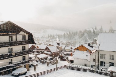 Rustic Charm: Village in a Snowy Mountain Setting clipart