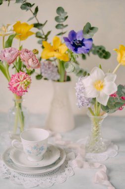 Elegant Breakfast Table Setting with Spring Flowers in Soft Tones clipart