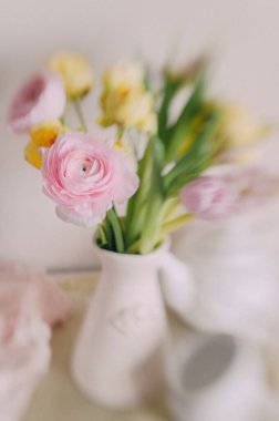 Soft Pastel Ranunculus and Yellow Roses in a Glass Vase clipart