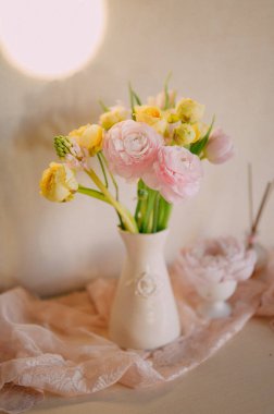 Soft Pastel Ranunculus and Yellow Roses in a Glass Vase clipart