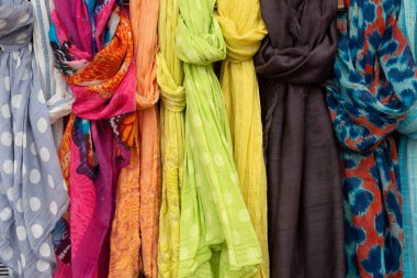 Many colorful clothing accessories hanging outside