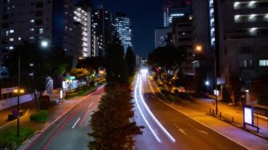 A night timelapse of the traffic jam at the city crossing in Tokyo. High quality 4k footage. Nakano district Higashinakano Tokyo Japan 10.11.2022 Here is an electric quarter in Tokyo. It is center of