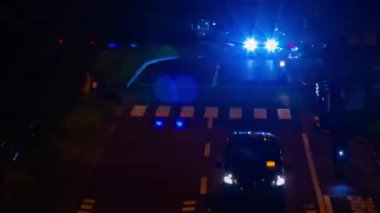 A night timelapse of the traffic jam at the city crossing in Tokyo. High quality 4k footage. Nakano district Higashinakano Tokyo Japan 10.11.2022 Here is an electric quarter in Tokyo. It is center of