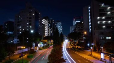 A night timelapse of the traffic jam at the city crossing in Tokyo. High quality 4k footage. Nakano district Higashinakano Tokyo Japan 10.11.2022 Here is an electric quarter in Tokyo. It is center of