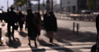 A slow motion of walking people on the street in the city. High quality 4k footage. Chuo district Tokyo Japan 01.18.2023 Here is an electric quarter in Tokyo. It is center of the city in Tokyo. 