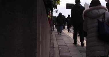 A slow motion of walking people on the street in the city. High quality 4k footage. Chuo district Tokyo Japan 01.18.2023 Here is an electric quarter in Tokyo. It is center of the city in Tokyo. 