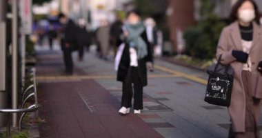 A slow motion of walking people on the street in the city. High quality 4k footage. Chuo district Tokyo Japan 01.18.2023 Here is an electric quarter in Tokyo. It is center of the city in Tokyo. 