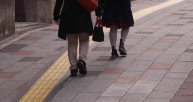 A slow motion of walking people on the street in the city. High quality 4k footage. Chuo district Tokyo Japan 01.18.2023 Here is an electric quarter in Tokyo. It is center of the city in Tokyo. 