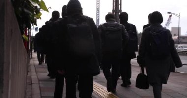 A slow motion of walking people on the street in the city. High quality 4k footage. Chuo district Tokyo Japan 01.18.2023 Here is an electric quarter in Tokyo. It is center of the city in Tokyo. 