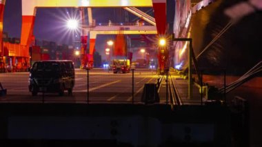 A night timelapse of crane near the container port in Aomi Tokyo. High quality 4k footage. Koto district Aomi Tokyo Japan 01.13.2023 It is a container port in Tokyo. 