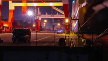 A night timelapse of crane near the container port in Aomi Tokyo. High quality 4k footage. Koto district Aomi Tokyo Japan 01.13.2023 It is a container port in Tokyo. 