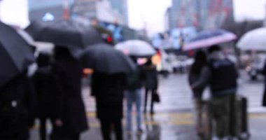 ShiBUYA 'da yağmurlu bir günde yürüyen insanlar. Yüksek kalite 4K görüntü. Shibuya bölgesi Tokyo 02.10.2023 Tokyo 'nun merkezidir.. 