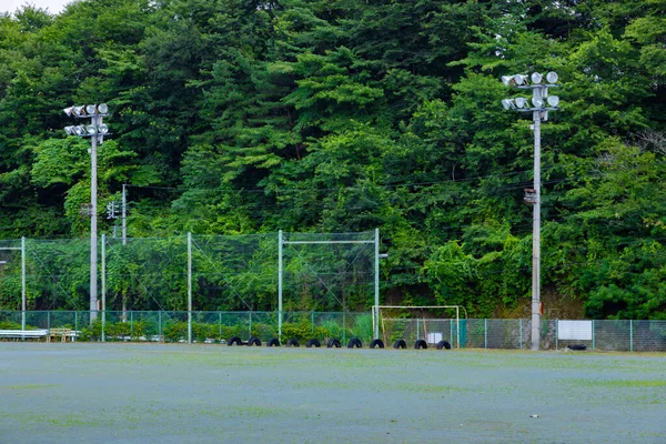 A ground of the closed elementary school at the country side in Gunma telephoto shot. High quality photo. Agatsuma district Nakanojo Gunma Japan 07.18.2023 It is a closed school at the country side in