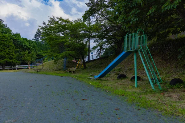 A playground equipment of the closed elementary school ground. High quality photo. Agatsuma district Nakanojo Gunma Japan 07.18.2023 It is a closed school at the country side in Gunma prefecture.