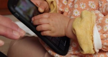 Akıllı telefonlu el kameralı bebek elleri 2x yavaş çekim. Yüksek kalite 4K görüntü. 02.17.2023