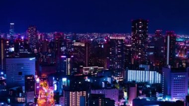 Osaka yüksek açılı panoramik şehir manzarasının gece zaman çizelgesi. Yüksek kalite 4K görüntü. Asahi Bölgesi Osaka Japonya 04.10.2023 Burası Osaka 'daki Takarazuka Demiryolu yakınında.. 