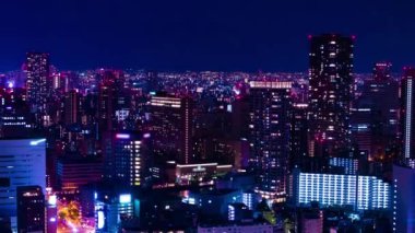 Osaka yüksek açılı panoramik şehir manzarasının gece zaman çizelgesi. Yüksek kalite 4K görüntü. Asahi Bölgesi Osaka Japonya 04.10.2023 Burası Osaka 'daki Takarazuka Demiryolu yakınında.. 