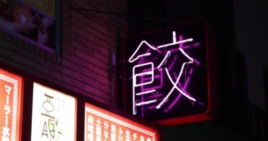 Tokyo şehir merkezinde bir neon şehir manzarası. Yüksek kalite 4K görüntü. Nerima bölgesi Nerima Tokyo Japonya 10.28.2022. Neon board metin Çin böreği çevirisi.