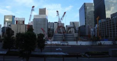 Mavi gökyüzünün arkasındaki inşaat halindeki vinçler hareket ediyor. Chiyoda Bölgesi Ariake Tokyo - 10.16.2019