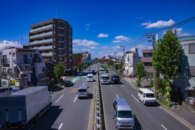 A timelapse of traffic jam at the downtown street in Tokyo wide shot. High quality photo. Nerima district Yahara Tokyo Japan 09.05.2023 clipart