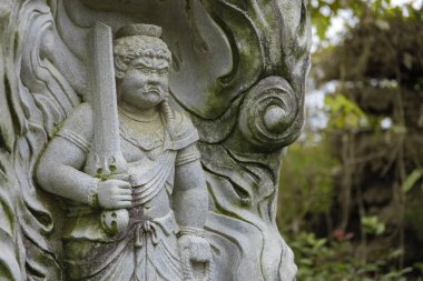 A buddhism stone statue at Japanese temple. High quality photo. Higashimurayama district Tokyo Japan 11.14.2024 It is a religious stone statue in Japanese temple. clipart