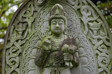 Japon tapınağında bir Budizm taşı heykeli. Yüksek kalite fotoğraf. Higashimurayama Bölgesi Tokyo Japonya 11.14.2024 Japon tapınağında bulunan bir dinsel taş heykel..