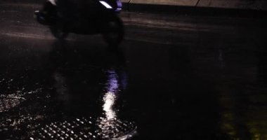 Geceleri şehir sokaklarında yavaş yavaş yağmur damlaları yağar. Yüksek kalite 4K görüntü. Zhongshan bölgesi Taipei Tayvan 04.12.2025