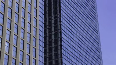 İş kasabasındaki ofis binasını yansıtan hareket eden bulutlar. Yüksek kalite 4K görüntü. Shinjuku Bölgesi Nishishinjuku Tokyo Japonya 06.27.2025 Tokyo 'nun merkezidir.. 