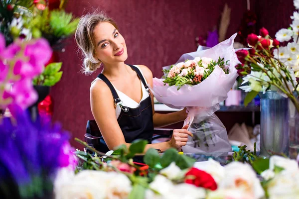 young woman flower store manager standing at workplace and smiling reopening shop sale.