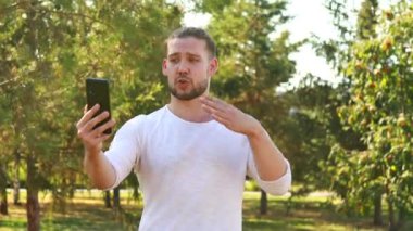 Beyaz ceketli mutlu adam yaz parkındaki arkadaşına ilginç bir hikaye anlatıyor..